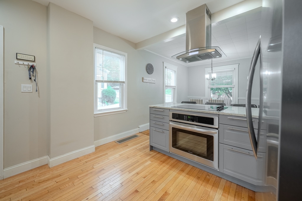 35 Lindenwood Road Stoneham, MA 02180 - Photo 12 of 37 a kitchen with stainless steel appliances granite countertop a stove a refrigerator and a microwave