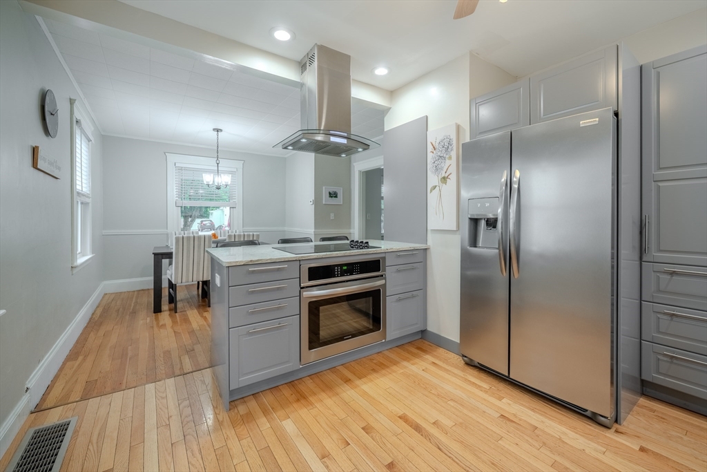 35 Lindenwood Road Stoneham, MA 02180 - Photo 13 of 37 a kitchen with stainless steel appliances kitchen island granite countertop a refrigerator and a stove