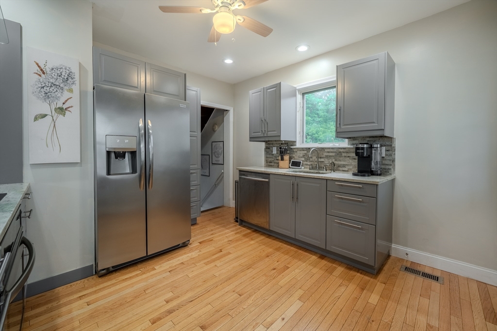 35 Lindenwood Road Stoneham, MA 02180 - Photo 15 of 37 a kitchen with stainless steel appliances granite countertop a refrigerator and a sink