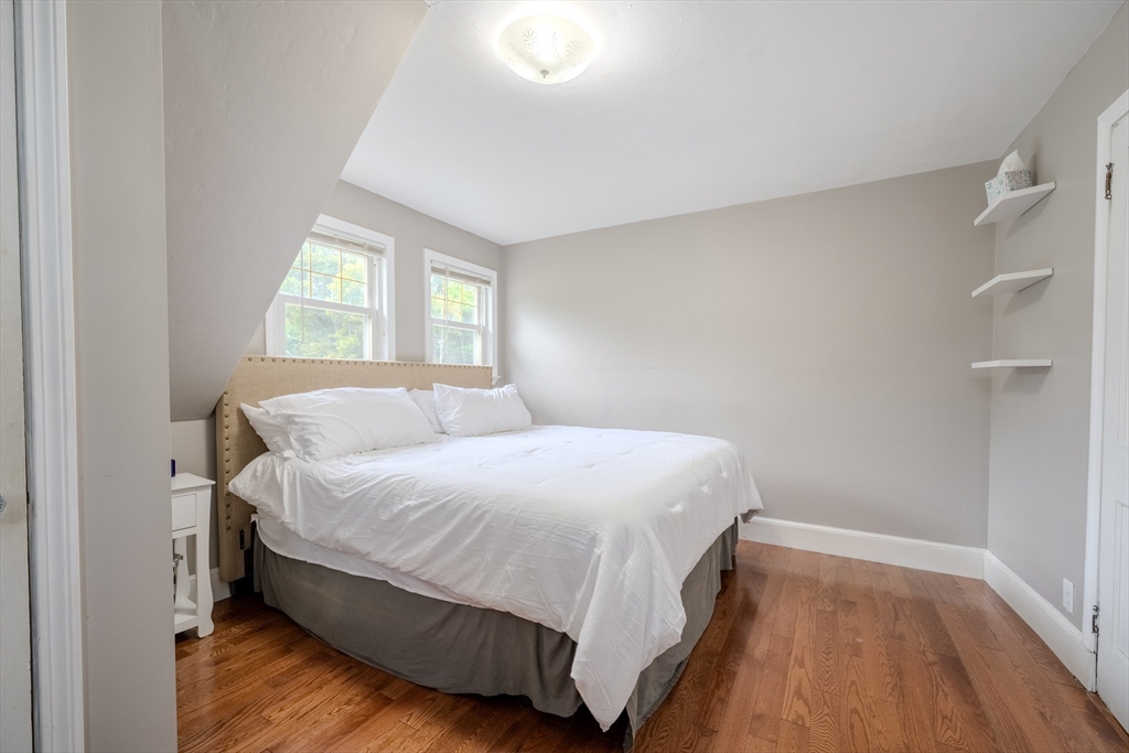 35 Lindenwood Road Stoneham, MA 02180 - Photo 17 of 37 a bedroom with a bed and wooden floor