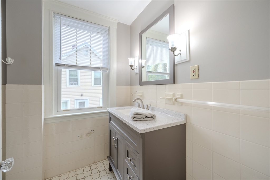 35 Lindenwood Road Stoneham, MA 02180 - Photo 20 of 37 a bathroom with a sink a vanity and a mirror