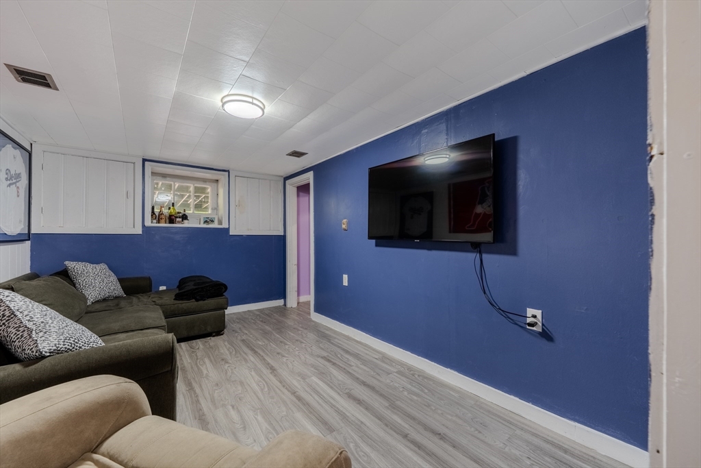 35 Lindenwood Road Stoneham, MA 02180 - Photo 28 of 37 a living room with furniture and a flat screen tv
