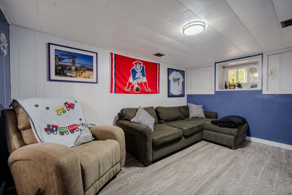 35 Lindenwood Road Stoneham, MA 02180 - Photo 29 of 37 a living room with couches and a painting on the wall