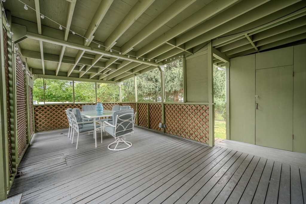 35 Lindenwood Road Stoneham, MA 02180 - Photo 34 of 37 a view of a backyard with table and chairs and wooden floor