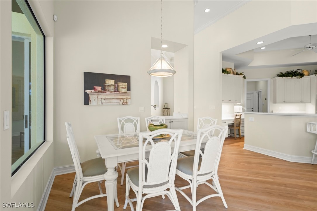 2337 Wulfert Road Sanibel, FL 33957 - Photo 15 of 45 a view of a dining room with furniture and wooden floor
