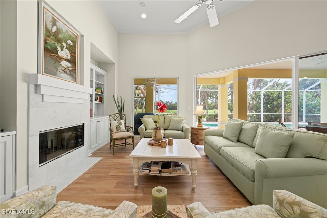 2337 Wulfert Road Sanibel, FL 33957 - Photo 17 of 45 a living room with furniture a fireplace and a floor to ceiling window
