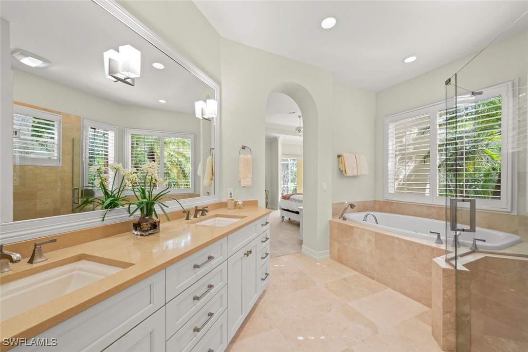2337 Wulfert Road Sanibel, FL 33957 - Photo 23 of 45 a spacious bathroom with sinks mirror and a bathtub