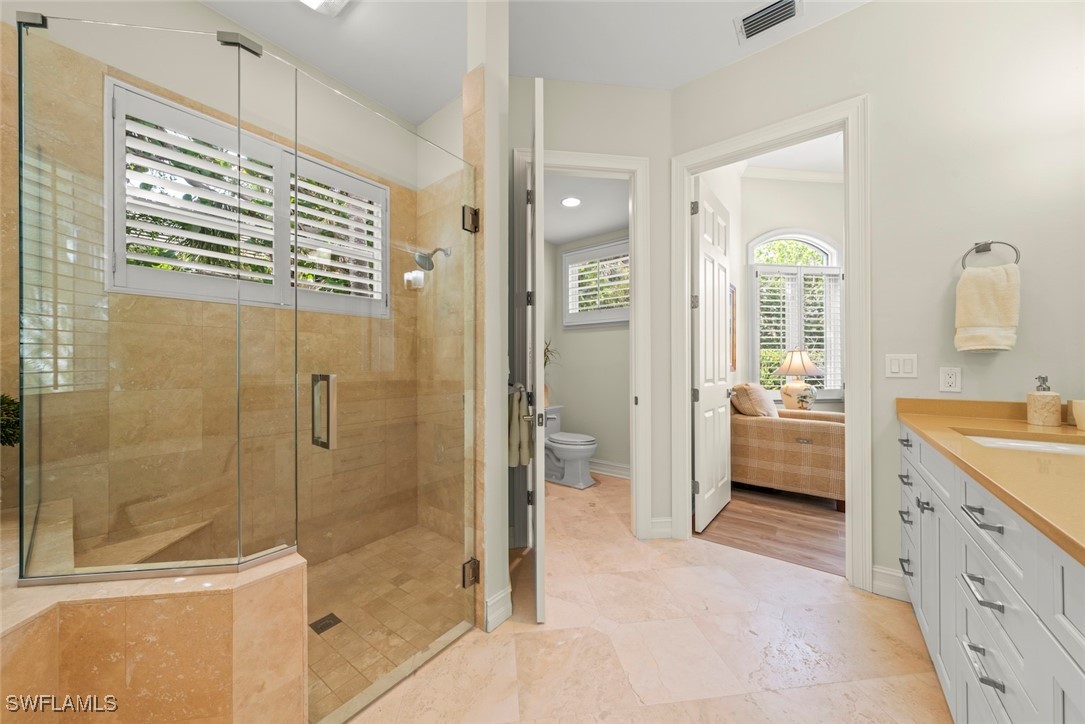 2337 Wulfert Road Sanibel, FL 33957 - Photo 25 of 45 a bathroom with a granite countertop sink a mirror a shower and a bathtub
