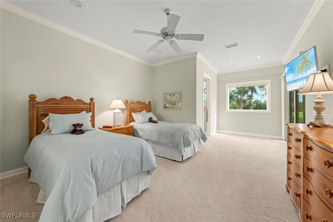 2337 Wulfert Road Sanibel, FL 33957 - Photo 26 of 45 a bedroom with two beds and a chandelier
