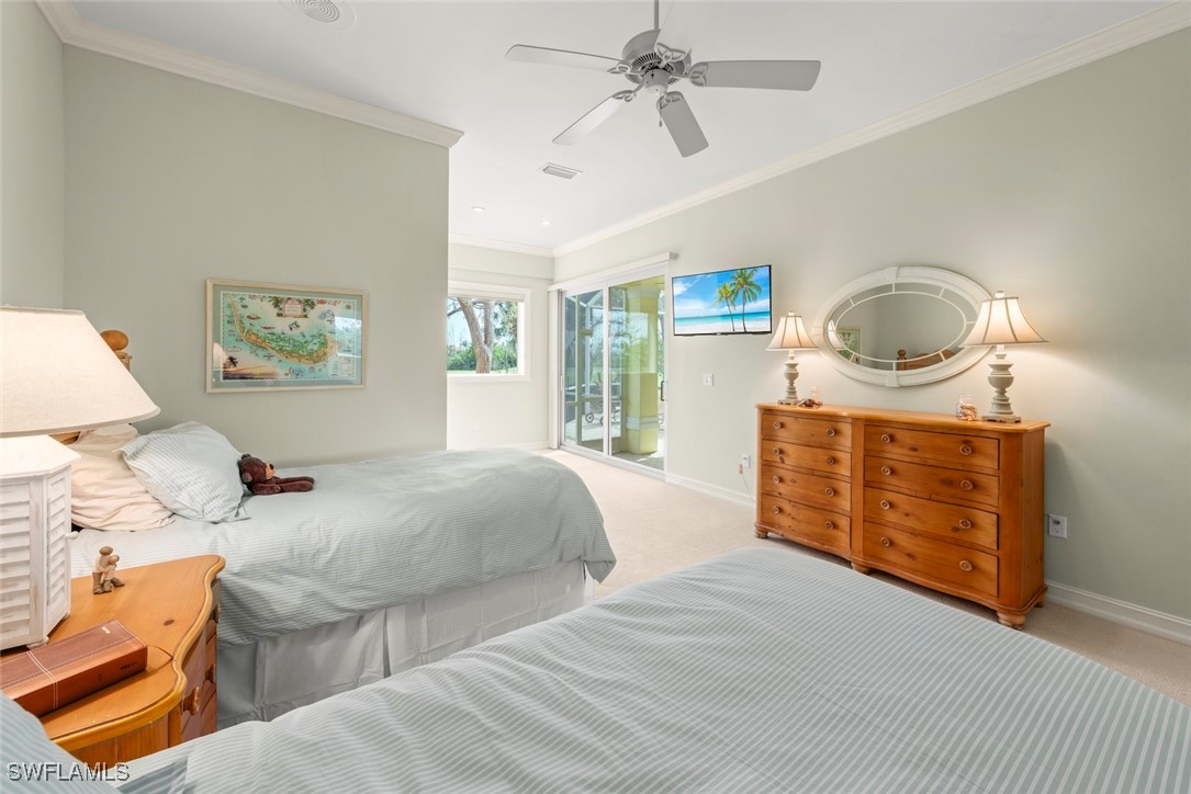 2337 Wulfert Road Sanibel, FL 33957 - Photo 27 of 45 a bedroom with a bed and a dresser