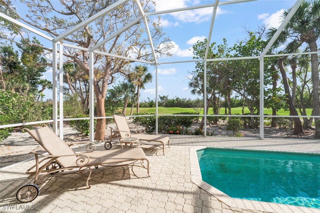 2337 Wulfert Road Sanibel, FL 33957 - Photo 37 of 45 a view of a swimming pool with a patio and a garden