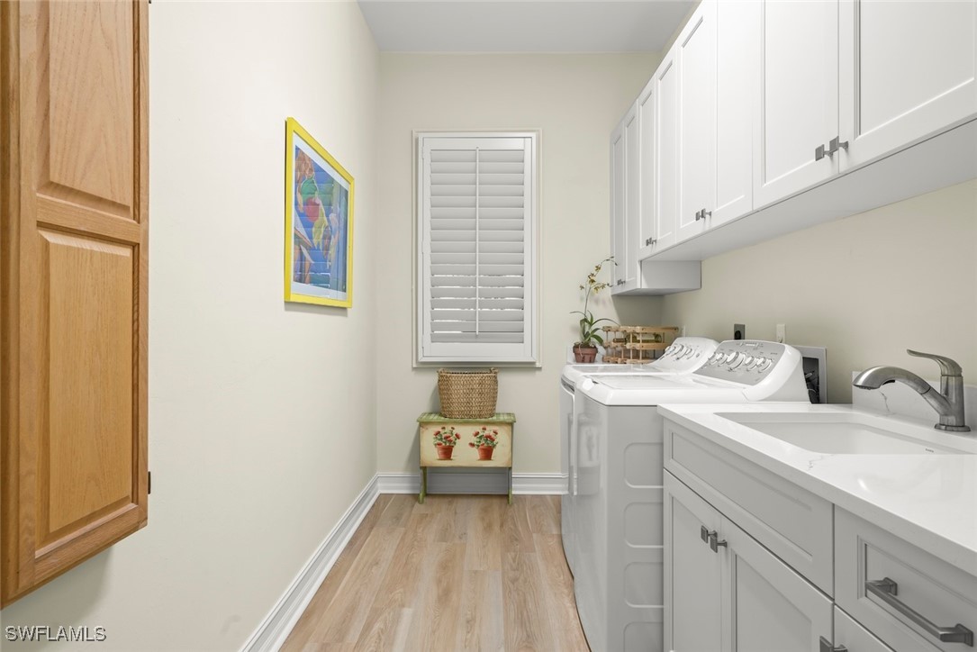 2337 Wulfert Road Sanibel, FL 33957 - Photo 40 of 45 a utility room with a sink dryer and washer