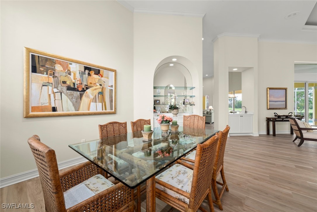 2337 Wulfert Road Sanibel, FL 33957 - Photo 6 of 45 a dining room with furniture and wooden floor