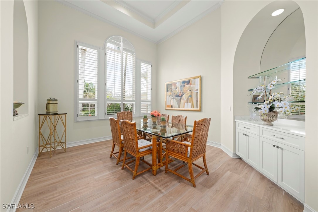 2337 Wulfert Road Sanibel, FL 33957 - Photo 7 of 45 a dining room with furniture a chandelier and wooden floor
