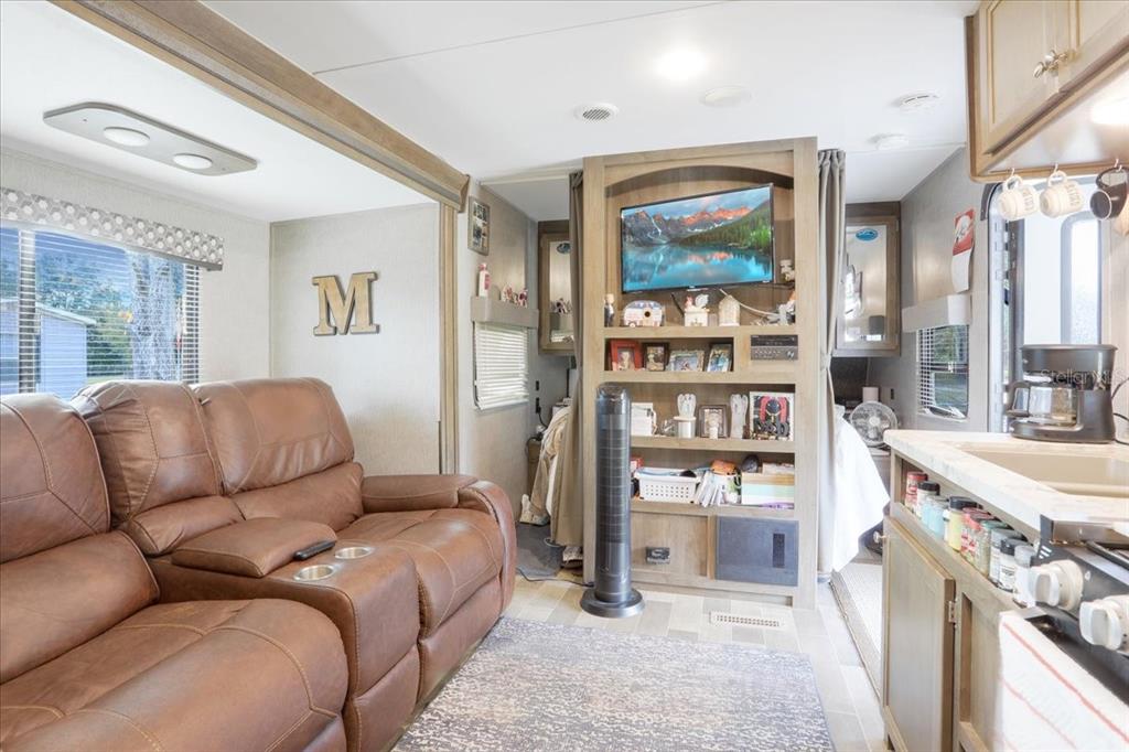 5336 County Road 791 Lake Butler, FL 32054 - Photo 17 of 25 a living room with furniture cabinets and a large window