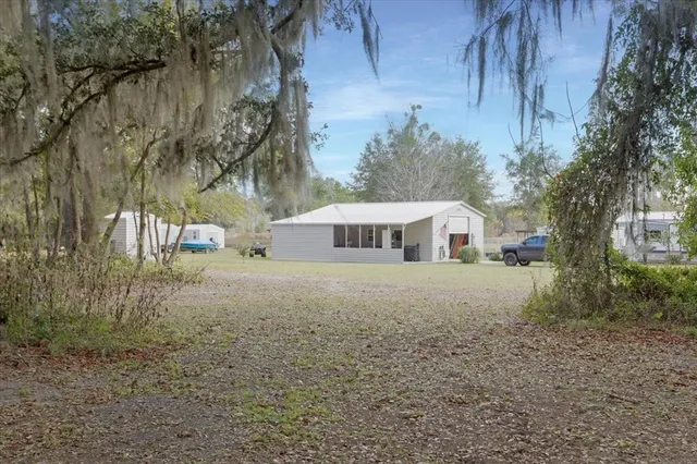 a house view with a trees in front of it