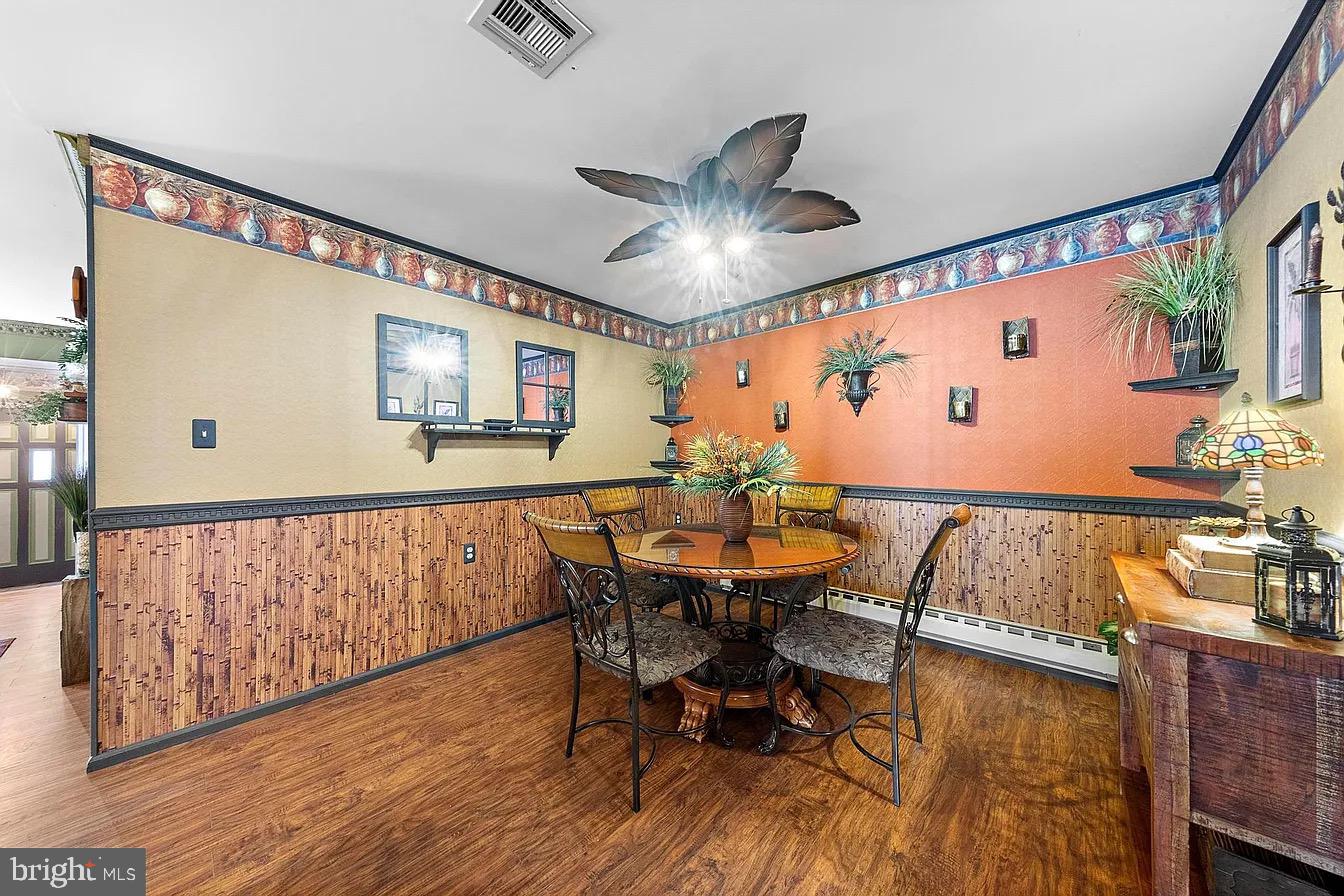 22 Fir Road Manahawkin, NJ 08050 - Photo 12 of 35 a view of a dining room with furniture window and wooden floor
