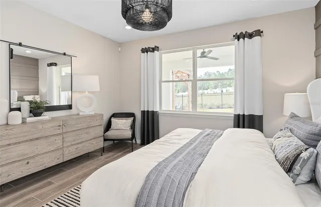 a bedroom with a bed and a large window