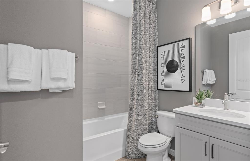 2382 Lily Bloom Road St. Cloud, FL 34771 - Photo 21 of 22 a bathroom with a sink toilet and shower