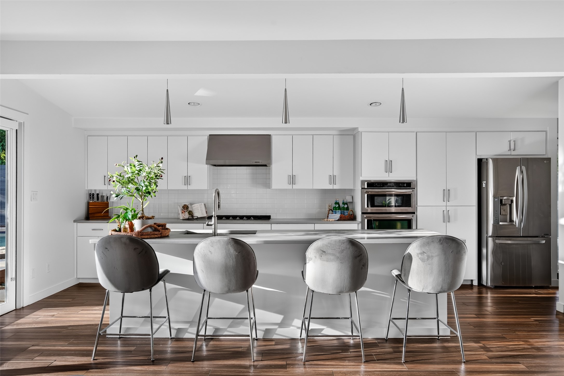 412 Ridgewood Road West Lake Hills, TX 78746 - Photo 10 of 40 A sleek modern kitchen with white cabinetry and an inviting island, perfect for entertaining.
