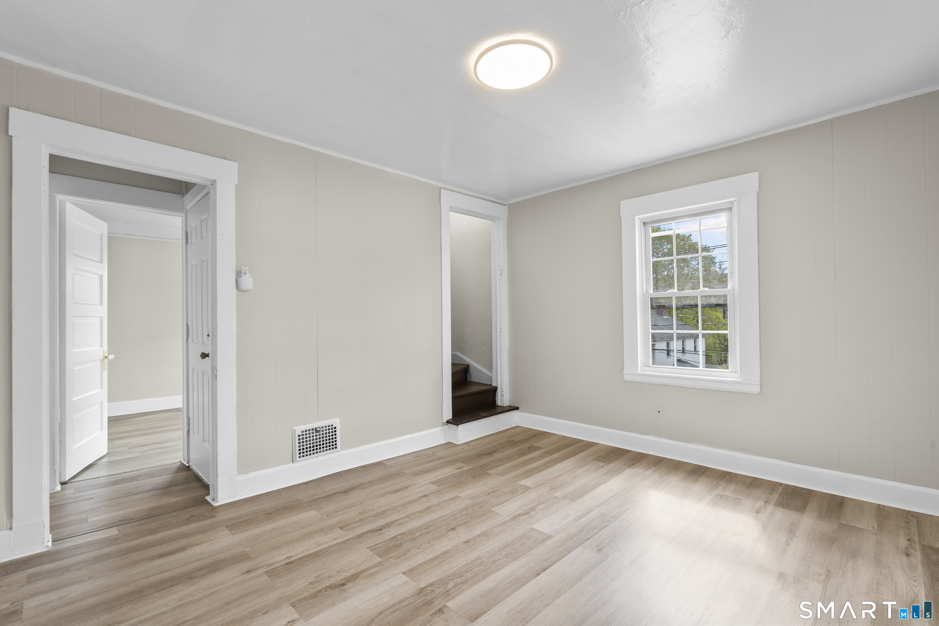 88 North Pond Street Bristol, CT 06010 - Photo 22 of 32 a view of an empty room with wooden floor and a window