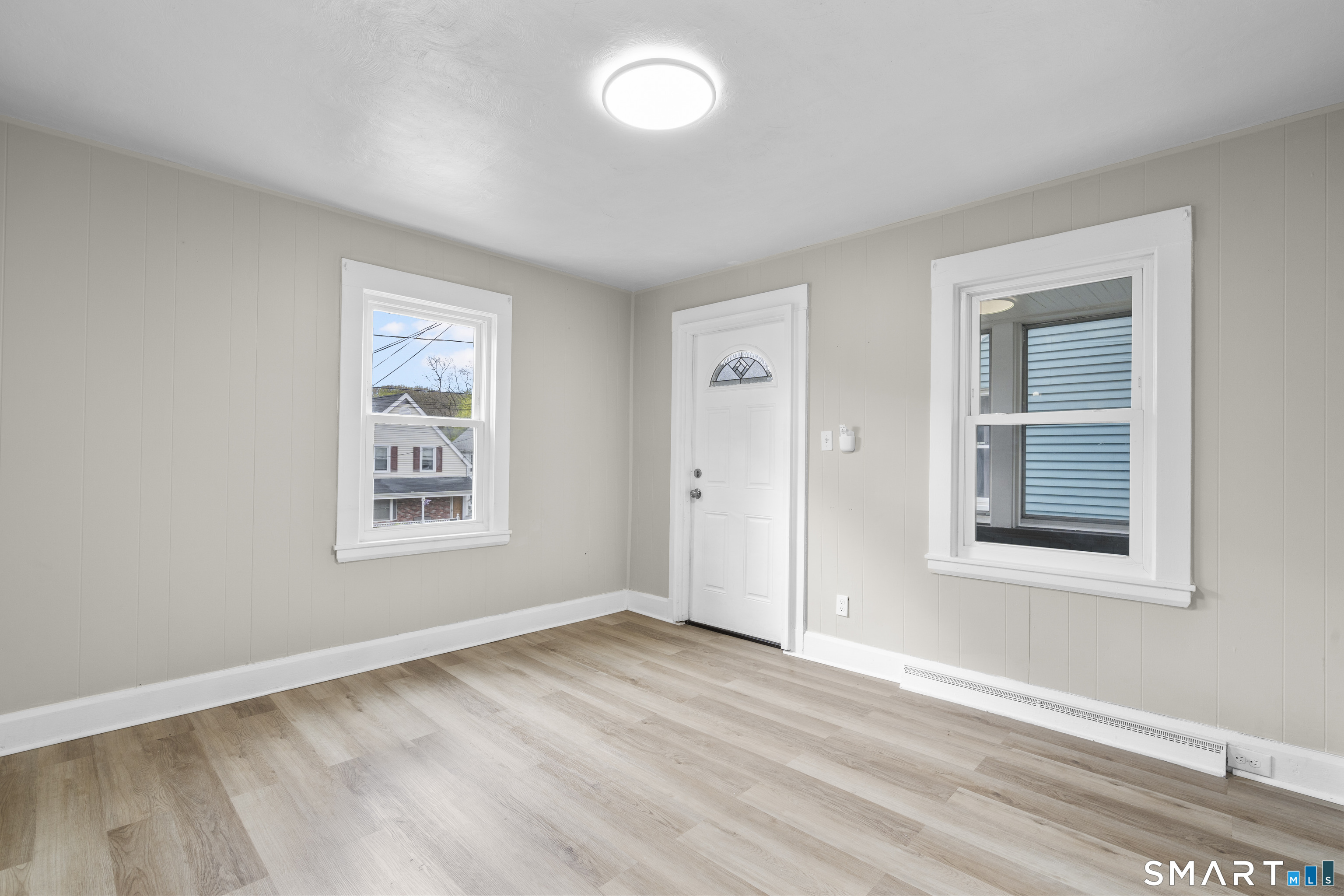 88 North Pond Street Bristol, CT 06010 - Photo 6 of 32 an empty room with wooden floor and windows