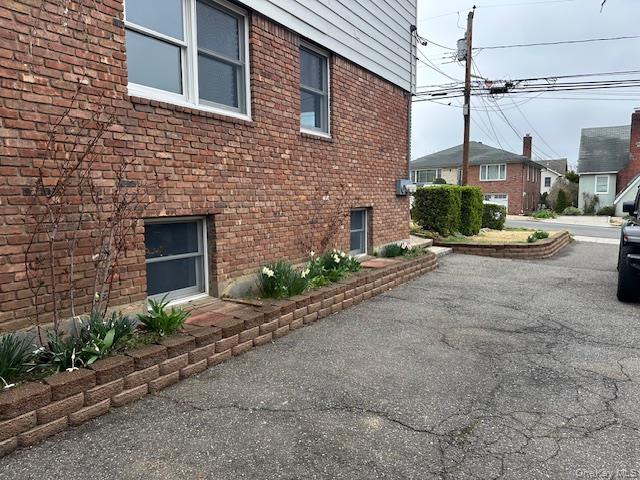 7 Linwood Road North, Unit 2 Port Washington, NY 11050 - Photo 12 of 13 View of home's exterior featuring brick siding