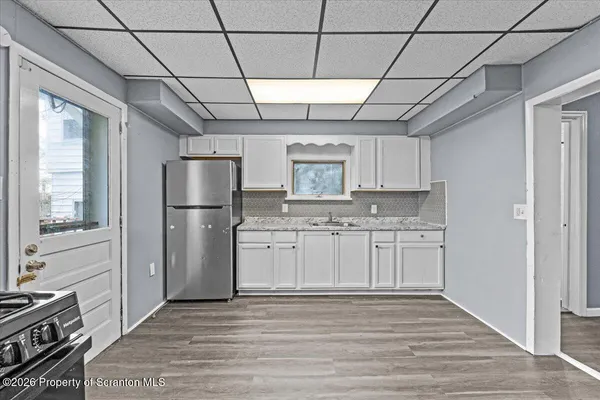 a kitchen with stainless steel appliances a refrigerator sink and cabinets