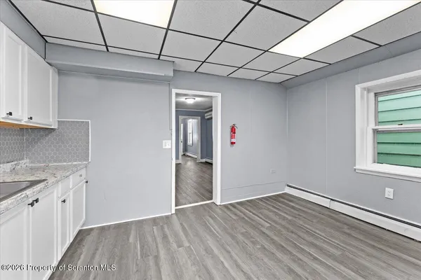 a view of hallway with wooden floor
