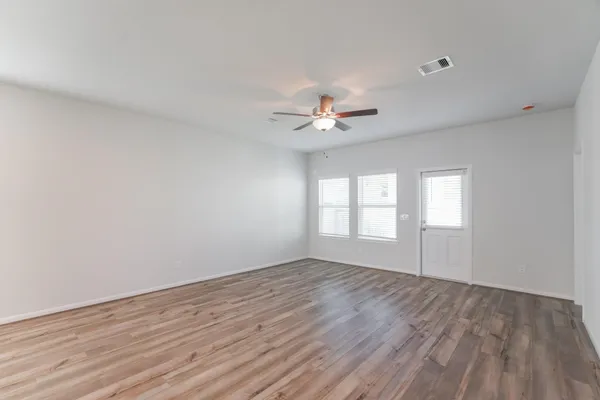 wooden floor in an empty room with a window
