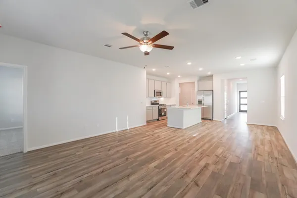 a view of a house with wooden floor and a kitchen view