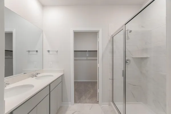 a bathroom with a shower sink and mirror