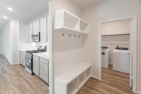 a kitchen with a refrigerator sink and cabinets