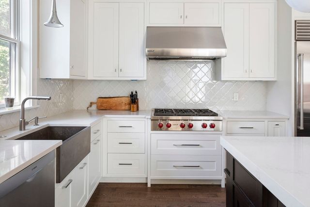 a kitchen with white cabinets and white appliances