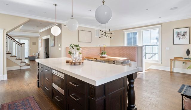 a large kitchen with a table and chairs