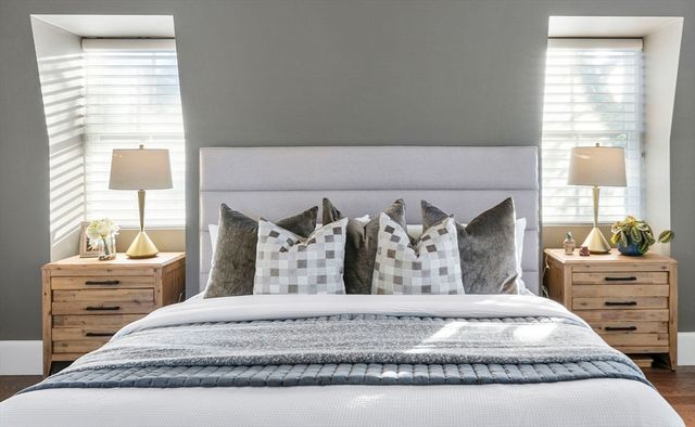 a bed sitting in a bedroom next to a window