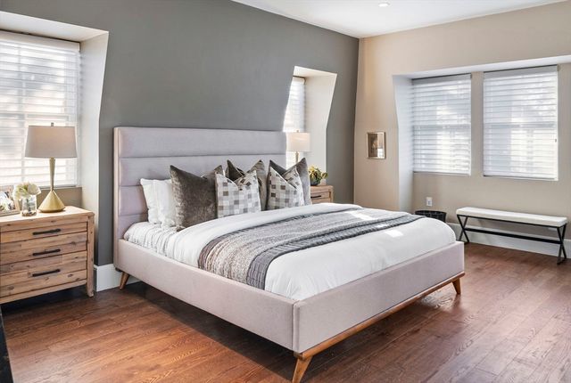 a bedroom with a bed and windows