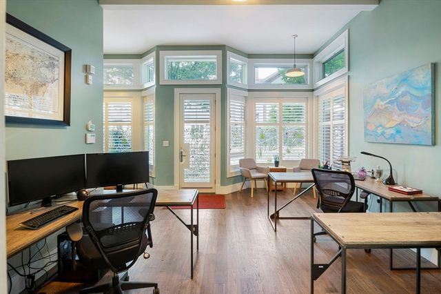 a view of a livingroom with workspace and a window
