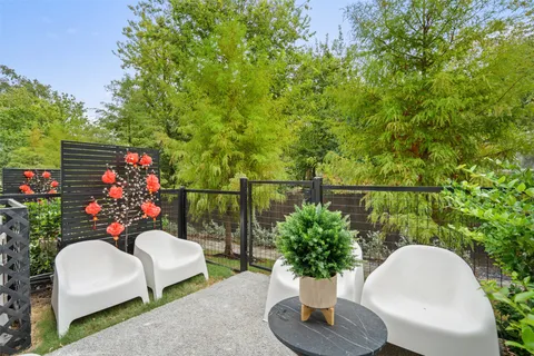 a view of a chairs and table in backyard