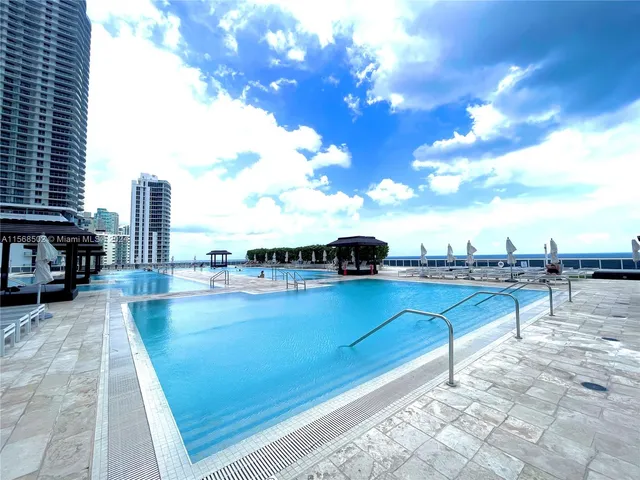 a room with gym equipment and large windows