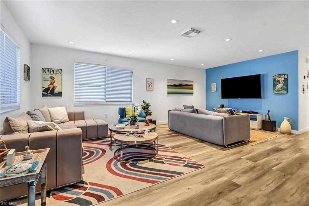 724 100th Avenue North Naples, FL 34108 - Photo 13 of 31 a living room with furniture and a flat screen tv