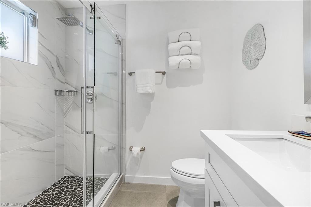724 100th Avenue North Naples, FL 34108 - Photo 21 of 31 a bathroom with a sink a toilet and shower