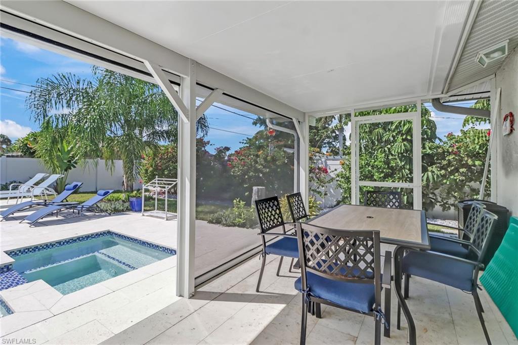 724 100th Avenue North Naples, FL 34108 - Photo 22 of 31 a view of an outdoor dining space with a table and chairs