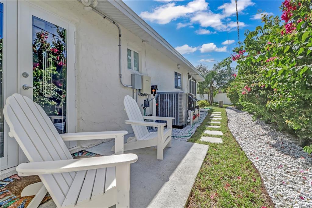 724 100th Avenue North Naples, FL 34108 - Photo 26 of 31 a view of an chairs and tables in the patio