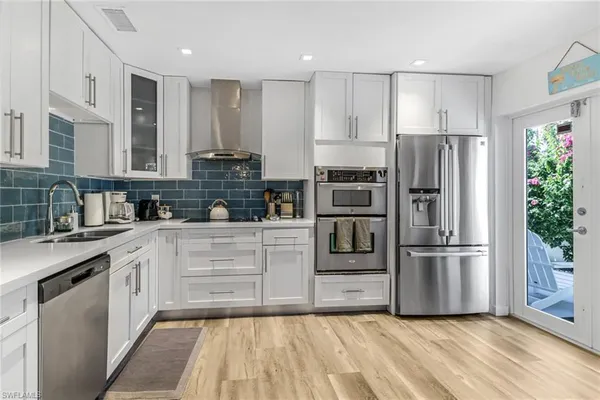a kitchen with granite countertop stainless steel appliances and refrigerator