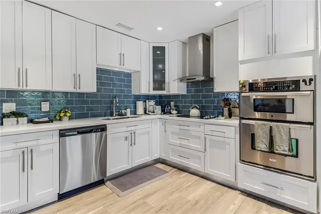 a kitchen with granite countertop white cabinets and white appliances