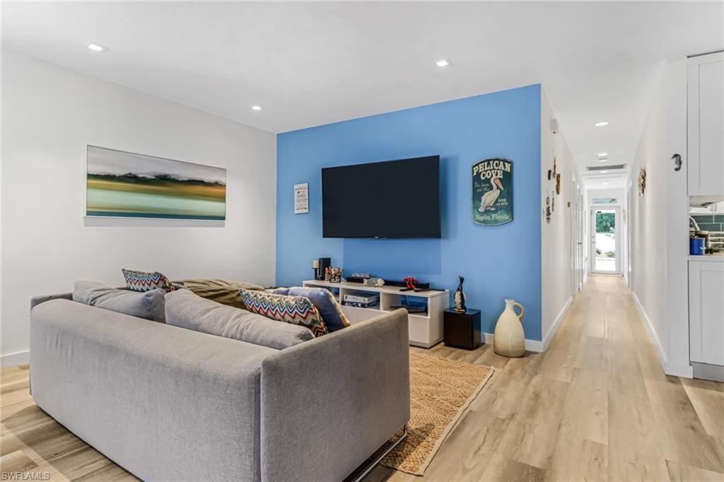 724 100th Avenue North Naples, FL 34108 - Photo 9 of 31 a living room with furniture and a flat screen tv