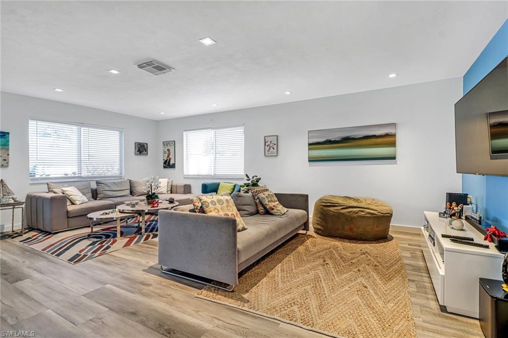 724 100th Avenue North Naples, FL 34108 - Photo 10 of 31 a living room with furniture and a large window