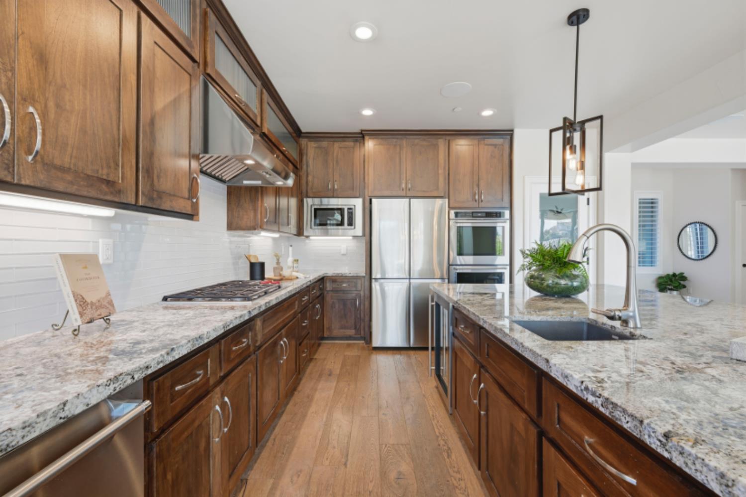 2714 Hidden Trail Loop Rocklin, CA 95765 - Photo 17 of 57 a large kitchen with granite countertop a sink counter space cabinets and stainless steel appliances