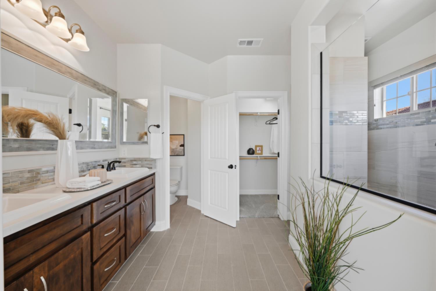 2714 Hidden Trail Loop Rocklin, CA 95765 - Photo 24 of 57 a kitchen with stainless steel appliances a sink a stove a refrigerator cabinets and living room view